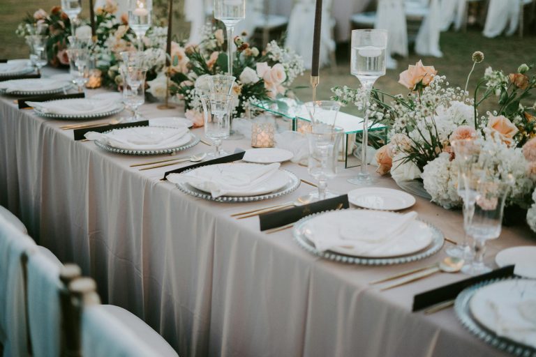 Beautifully decorated wedding reception table with floral arrangements and elegant tableware.